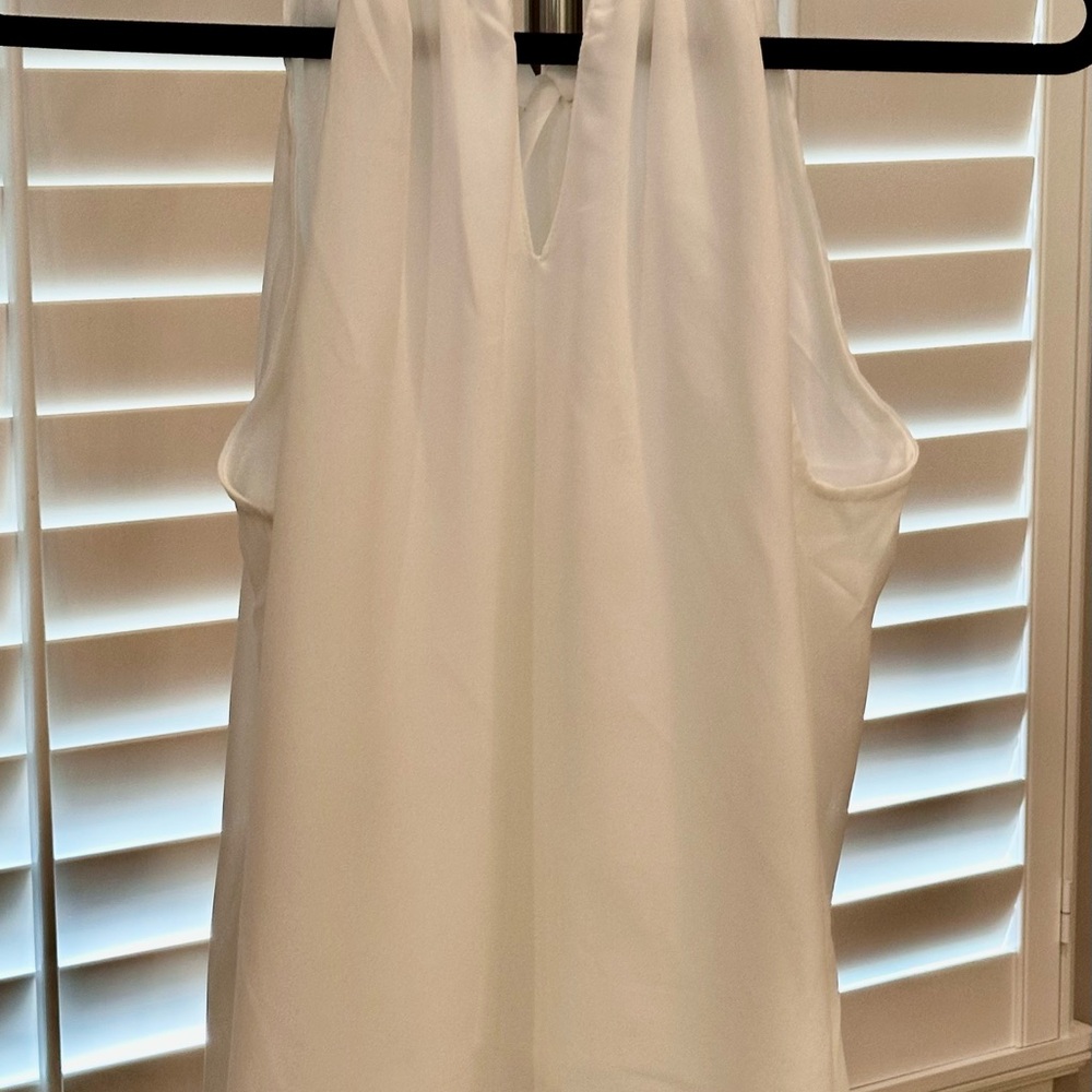 Elegant White Sleeveless Top with tie in the back.
